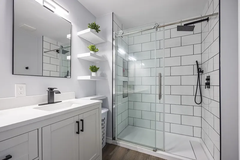 Bathroom with tiled walk-in shower and floating shelves